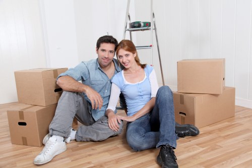 Business staff preparing an office for relocation with labelled boxes