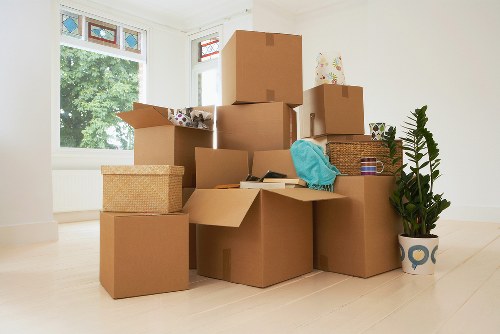 Packed moving boxes and furniture ready for transport in a Barnet home